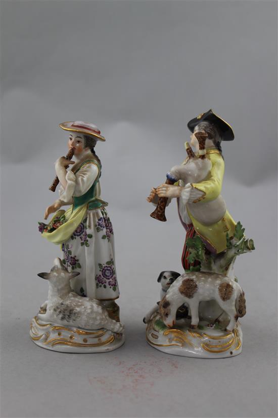 A pair of Meissen groups of a musical shepherd and shepherdess, 20th century, 16cm. and 15cm., minor losses to leaves